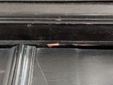 a close up of a window frame with peeling paint on it