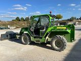 a picture of a green tractor parked in a parking lot