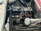 an old car engine in the back of it ' s truck