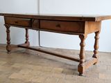 a wooden table with two drawers on top of it