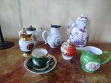 many different types of teapots and cups on the table