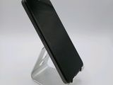 an image of a cell phone on a stand on a white surface