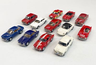 several toy cars are lined up in a row on a white surface