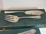 two forks and a knife sitting on a green box
