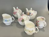 five different types of teapots and cups on the table