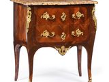 an antique chest of drawers with a marble top and gold decoration