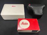 two boxes of leica cameras sitting next to each other on a table