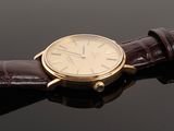 a close up of a wrist watch with a brown leather strap