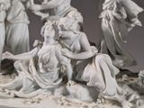a statue of a group of people that are sitting on the ground