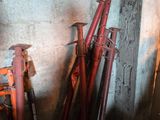 a pile of old baseball bats sitting against a wall