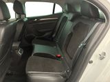the back seats of a white car with a black seat belt