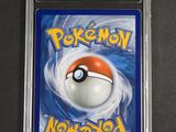 a close up of a pokemon card on a black surface
