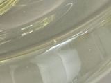 a close up of a glass container with a toothbrush inside of it