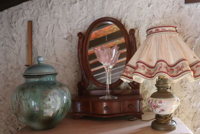 a table with a lamp and a vase on it