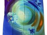 a close up of a blue and green flag with butterflies on it