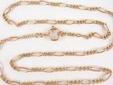 a close up of a gold chain on a white background