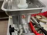 a meat grinder sitting on a counter in a kitchen