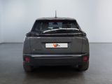 the rear end of a grey car with a number plate on the back of it