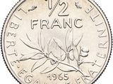 a close up of a silver coin with a flower on it