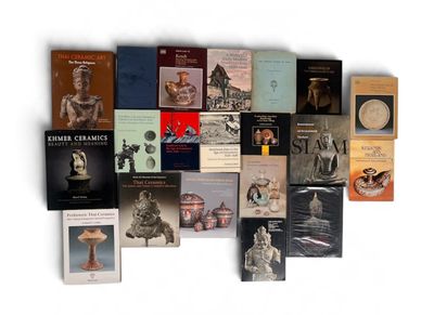 a lot of books that are on a white surface