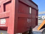 an image of a red dump truck parked on the side of the road