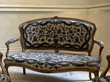 a blue and white couch and two chairs in a room