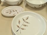 several plates and bowls are sitting on a table in a room