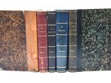 plusieurs vieux livres sont empilés sur une étagère