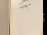 an open book with a poem on it on a table