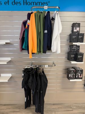 a rack of clothes on a wall in a store