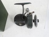 a fishing reel sitting on the floor next to a door