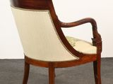 an image of a wooden chair with a beige upholstered seat