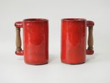 pair of red mugs with wooden handles on a white background