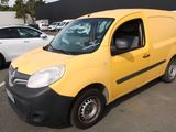 a yellow van that is parked in a parking lot