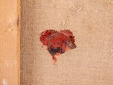 a small piece of red paint on a piece of burlock paper