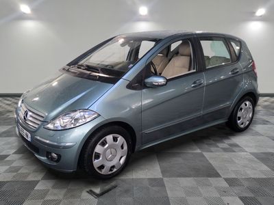 a picture of a small blue car parked in a garage
