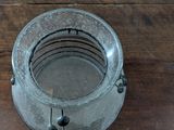 a small metal container on a wooden table