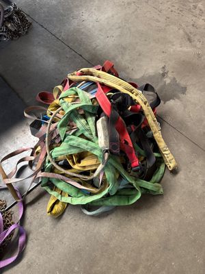a pile of different colored leashes on the ground