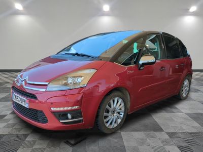 the red citrole is parked on a checkered tile floor