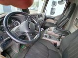 a man that is sitting in the driver ' s seat of a truck