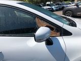 a dog sticking its head out of the window of a car