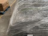 many rolls of wire wrapped in plastic in a warehouse