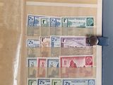an open book with stamps on it on a table