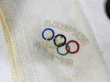 a close up of a white shirt with the olympic rings on it