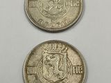two silver coins with a crown on top of each other