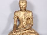statue of a seated buddha on a white background