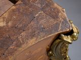 a close up of a wooden clock with a metal handle