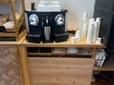 a coffee machine sitting on top of a counter in a coffee shop