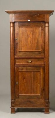 an old wooden cabinet with two doors and a drawer underneath it