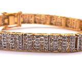 a close up of a gold bracelet with diamonds on it